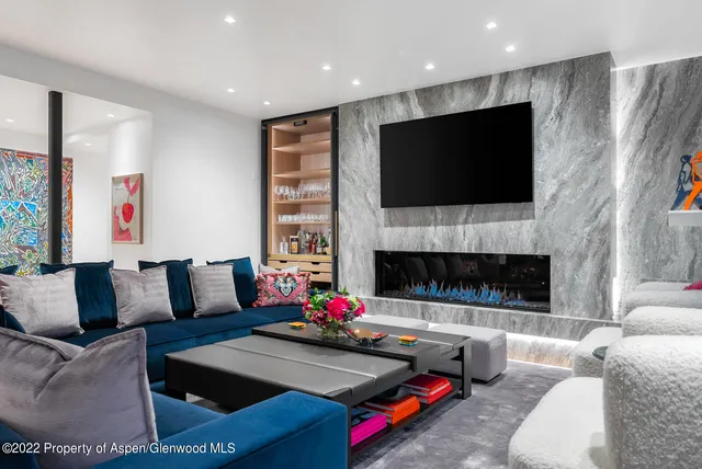 a living room with furniture fireplace and flat screen tv