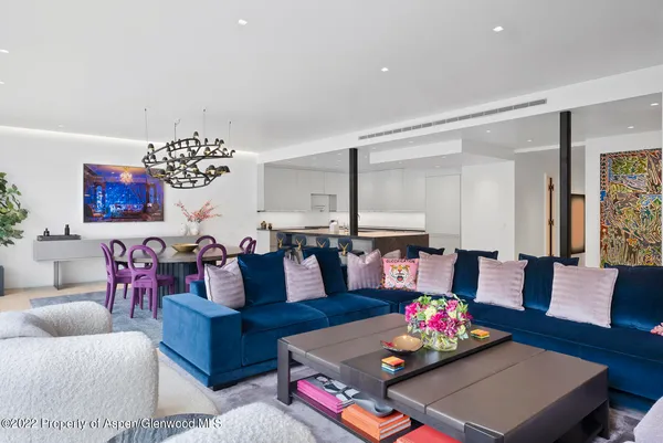 a living room with furniture and a chandelier