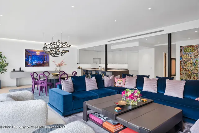 a living room with furniture and a chandelier