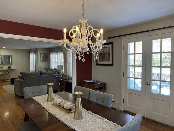 a living room with furniture chandelier and a window