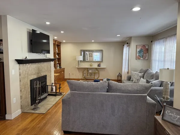 a living room with fireplace furniture and a flat screen tv