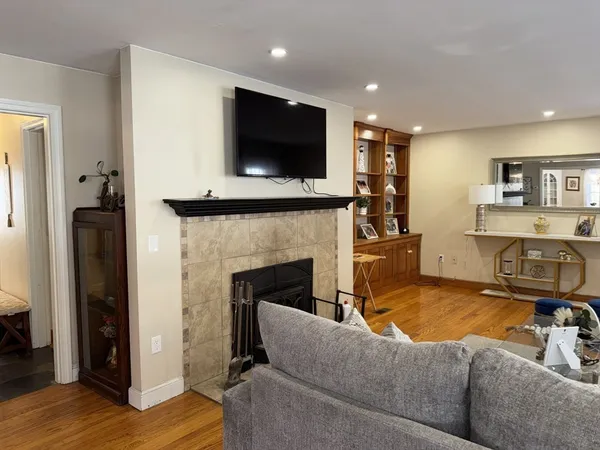 a living room with furniture a flat screen tv and a fireplace