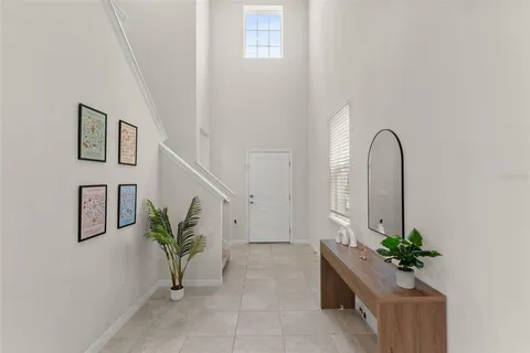 a living room with furniture and potted plant