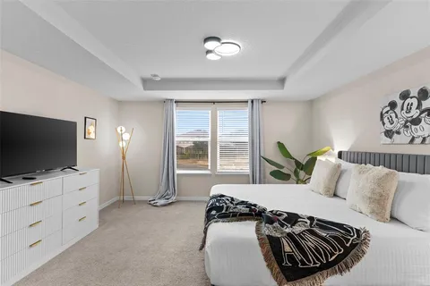 a bedroom with furniture and a flat screen tv