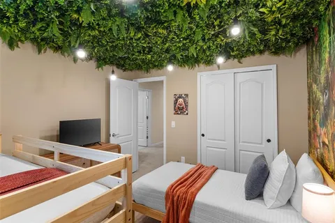 a bedroom with a bed and a tree