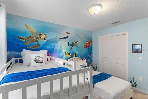 a bedroom with furniture and a wooden floor