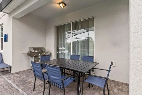a view of a wooden table and chairs in patio