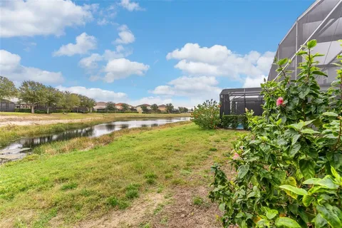 a view of a lake with houses in the back