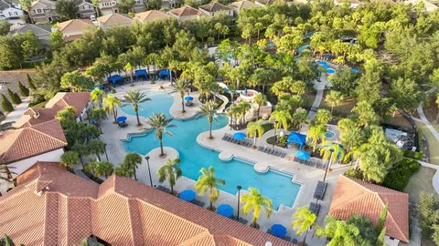 a view of a tennis ground with large trees