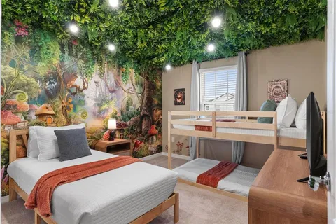 a bedroom with a bed table and chairs