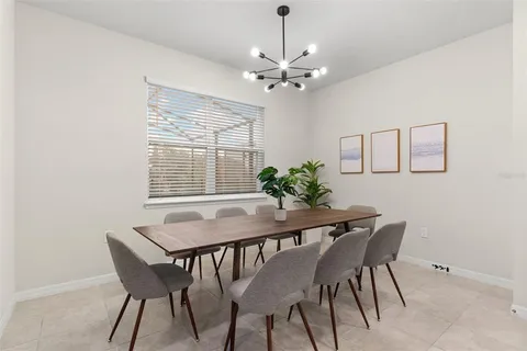 a view of a dining room with furniture and chandelier
