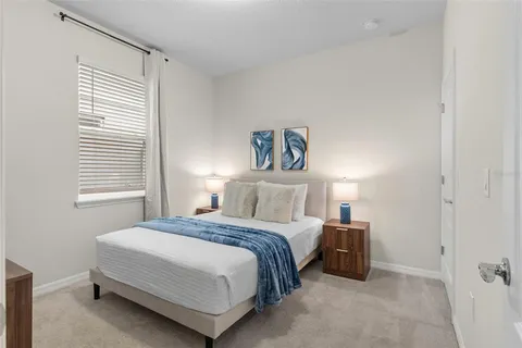 a bedroom with a bed and a night stand