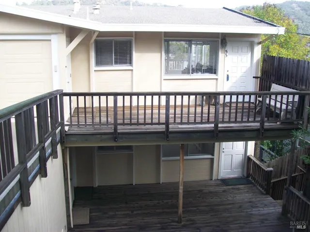 a view of a chair and table in the balcony