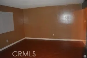 an empty room with wooden floor