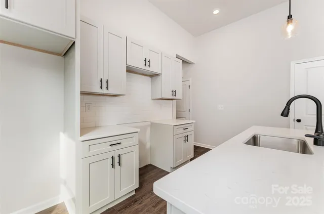 a kitchen with white cabinets and white appliances