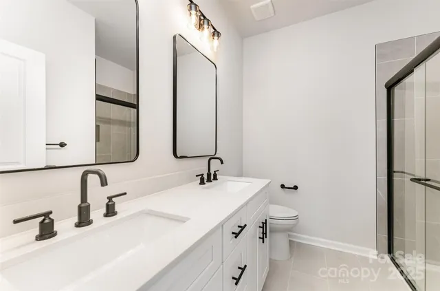 a bathroom with a double vanity sink and a mirror