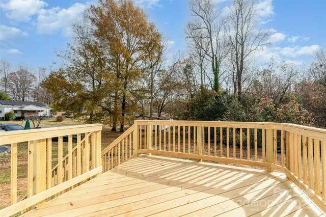 a view of a wooden deck and trees