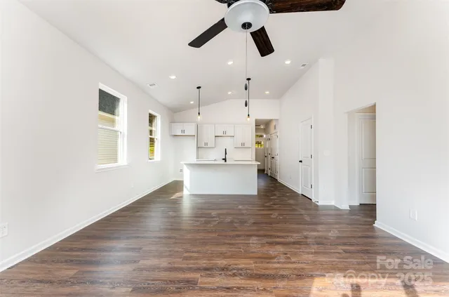 a view of a kitchen with wooden floor and a sink