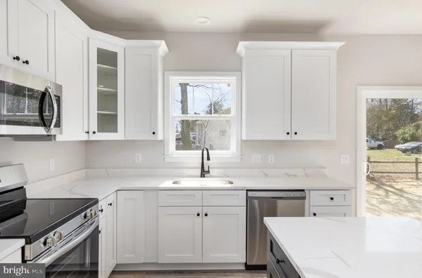 a kitchen with a sink stove and cabinets