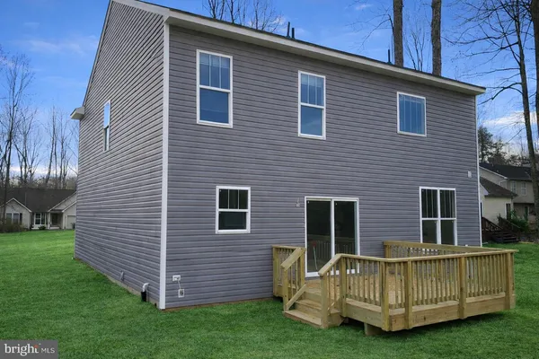 a view of backyard with a garden and deck
