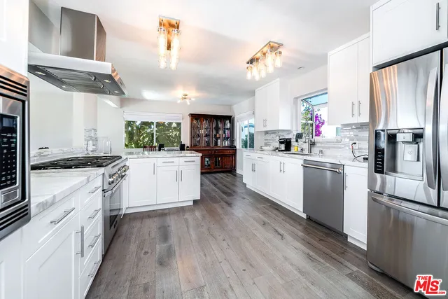 a kitchen with a stove a sink and a refrigerator