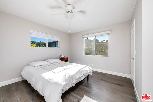 a bathroom with a granite countertop sink a mirror and shower