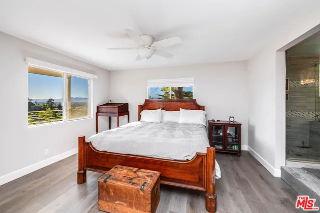 a bedroom with a large bed and a chandelier