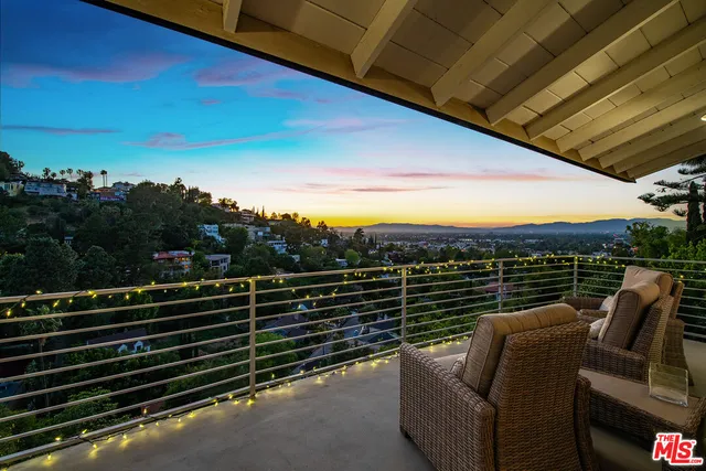 a view of balcony with furniture