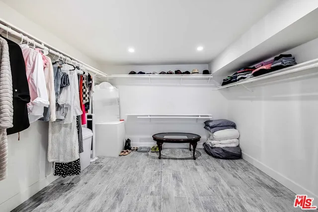 a large bedroom with a bed and a large window