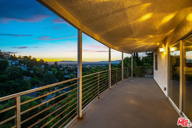 a view of balcony with wooden floor and fence