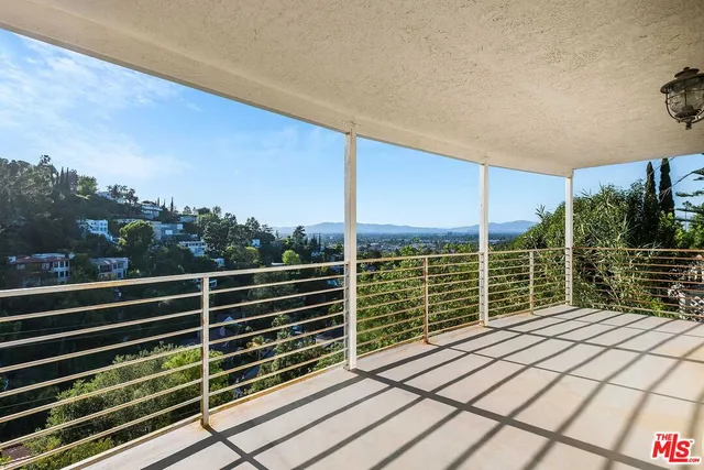 a view of balcony with wooden floor and fence