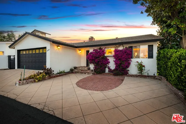 a view of a garden with a building in the background