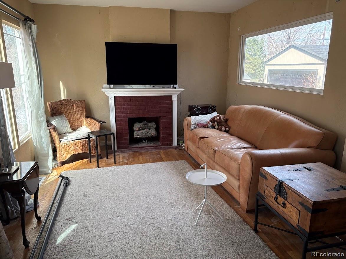 3520 High Court Wheat Ridge, CO 80033 - Photo 3 of 14 a living room with furniture a flat screen tv and a fireplace
