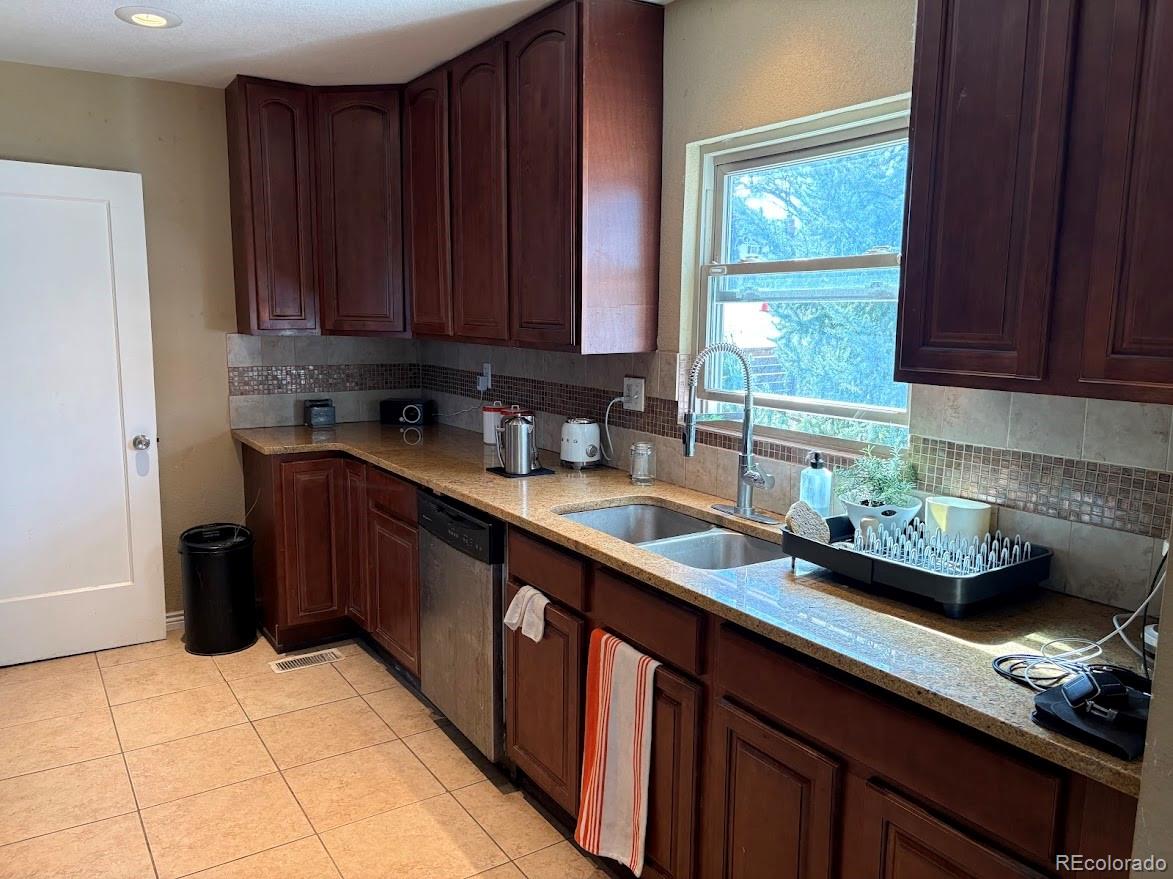 3520 High Court Wheat Ridge, CO 80033 - Photo 5 of 14 a kitchen with stainless steel appliances granite countertop a sink stove and cabinets