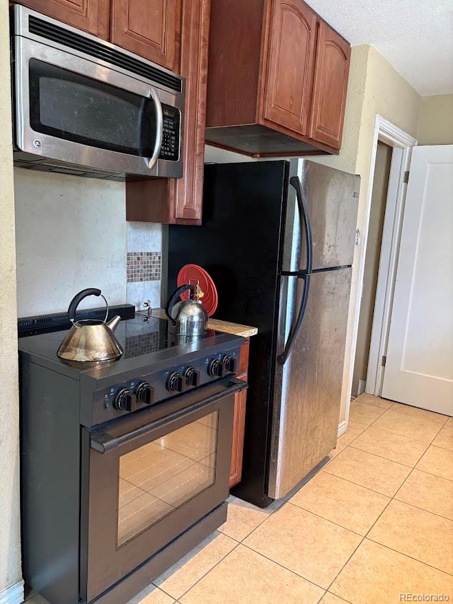 3520 High Court Wheat Ridge, CO 80033 - Photo 6 of 14 a kitchen with stainless steel appliances granite countertop a stove microwave and refrigerator