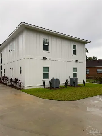 a view of a white house with a yard