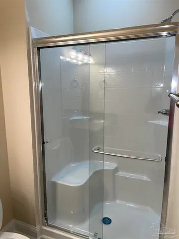 a bathroom with a glass shower door