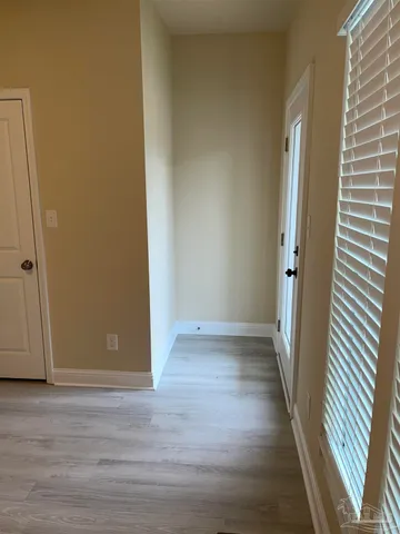 a view of a hallway with wooden floor