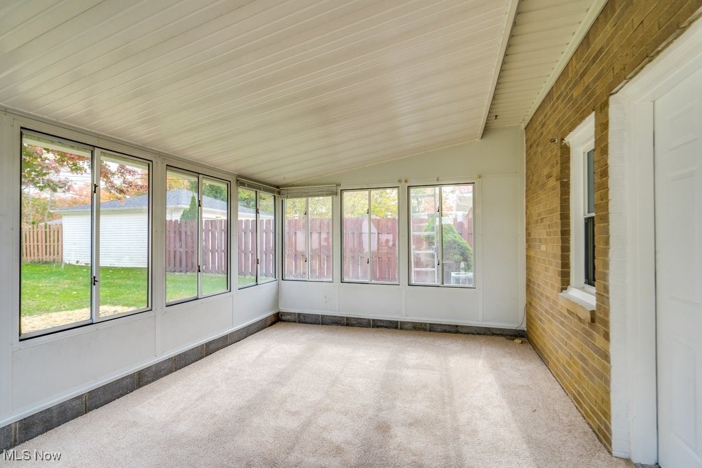 6961 Maplewood Road Parma Heights, OH 44130 - Photo 20 of 22 Unfurnished sunroom with lofted ceiling and plenty of natural light