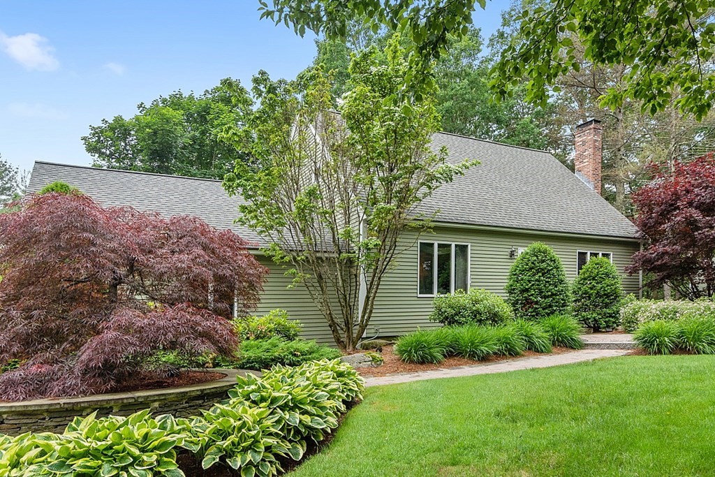 241 Hill Road Groton, MA 01450 - Photo 4 of 42 a view of a house with a yard and garden