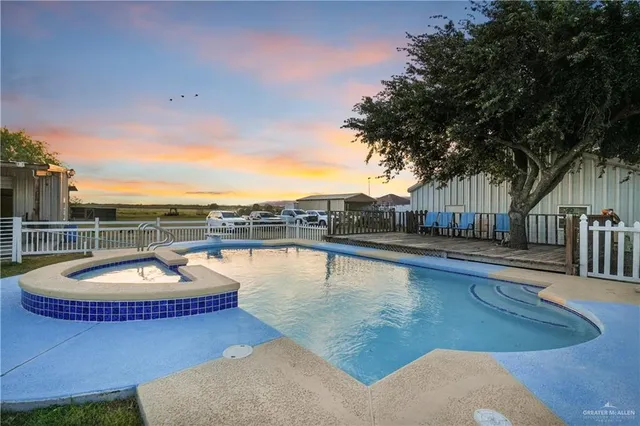 a view of a swimming pool with a lounge chair