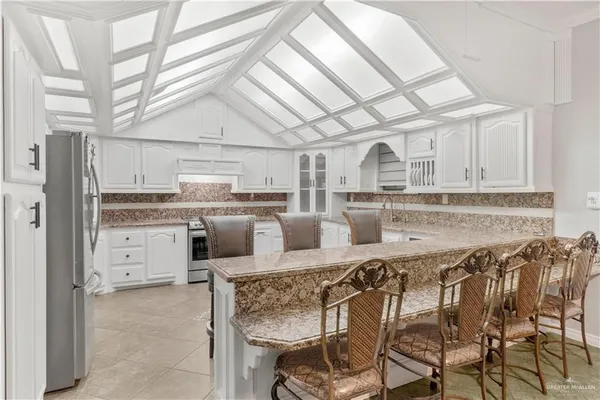 a view of a dining room with furniture and chandelier