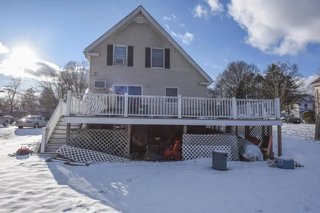 a view of a chairs and table in the back yard of the house
