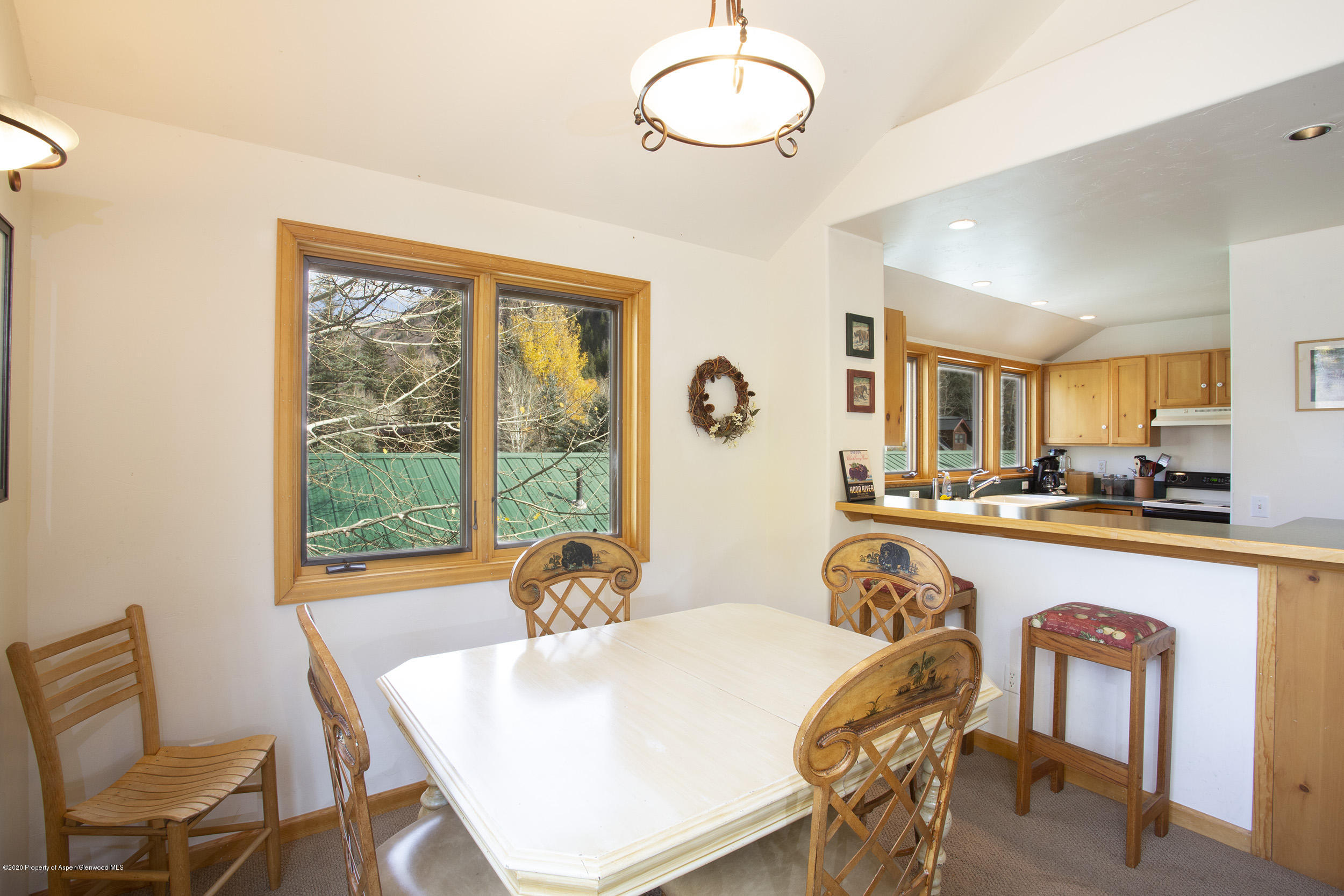 385 Redstone Boulevard Redstone, CO 81623 - Photo 13 of 36 a very nice looking dining room with kitchen island furniture a large window and a sink