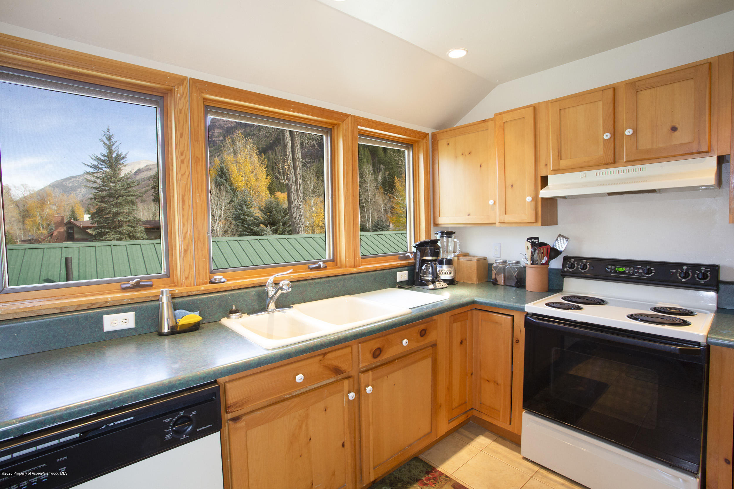 385 Redstone Boulevard Redstone, CO 81623 - Photo 15 of 36 a kitchen with a sink stove and cabinets