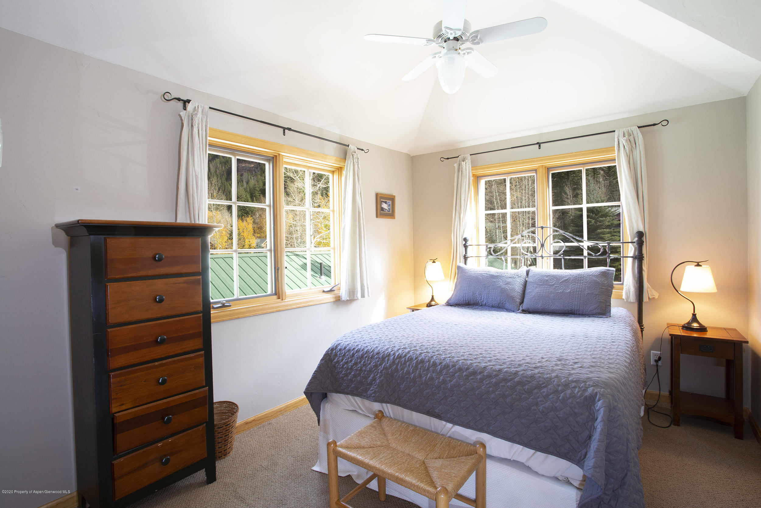385 Redstone Boulevard Redstone, CO 81623 - Photo 16 of 36 a bedroom with a bed and a window