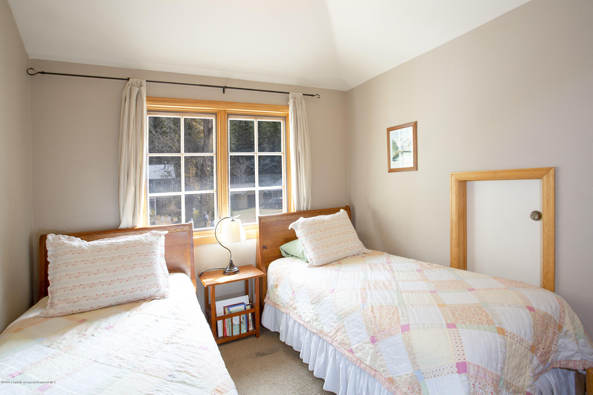 385 Redstone Boulevard Redstone, CO 81623 - Photo 17 of 36 a bedroom with a bed and a window