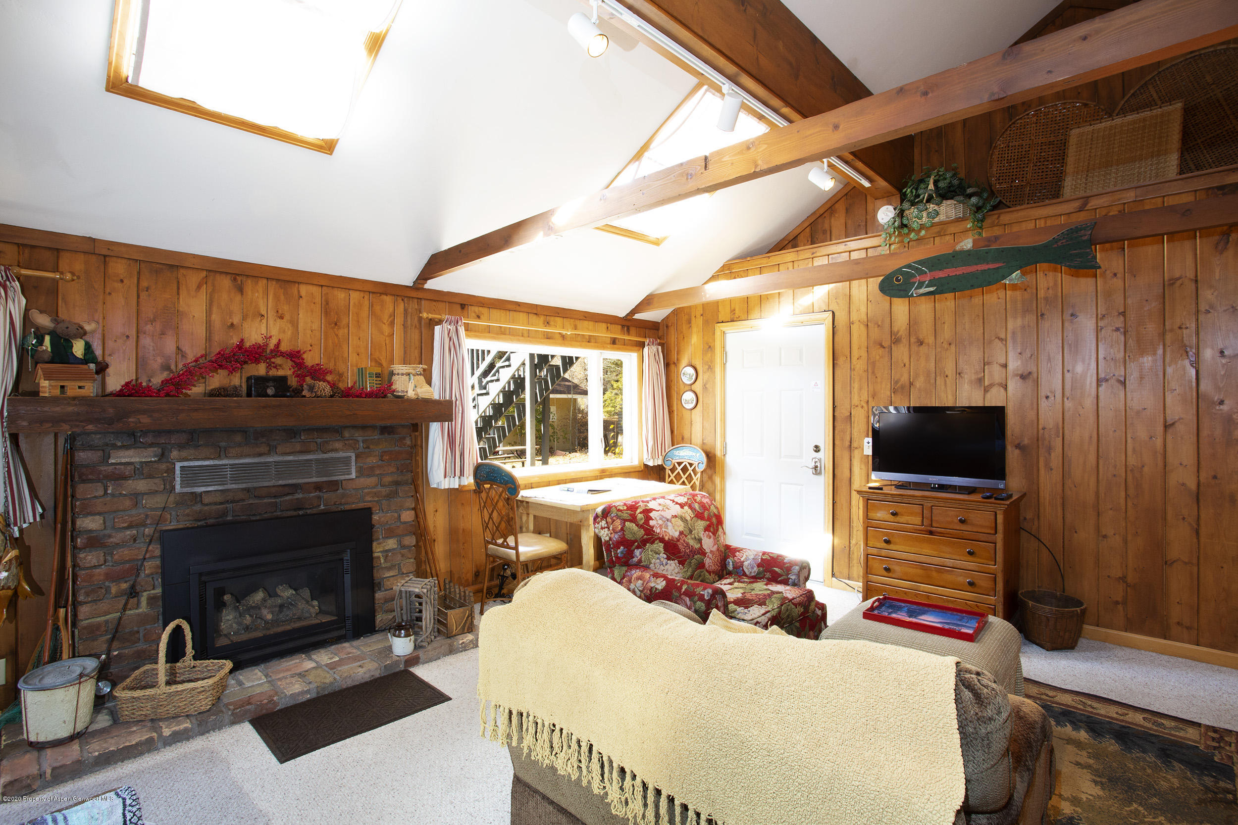 385 Redstone Boulevard Redstone, CO 81623 - Photo 23 of 36 a living room with furniture a flat screen tv and a fireplace