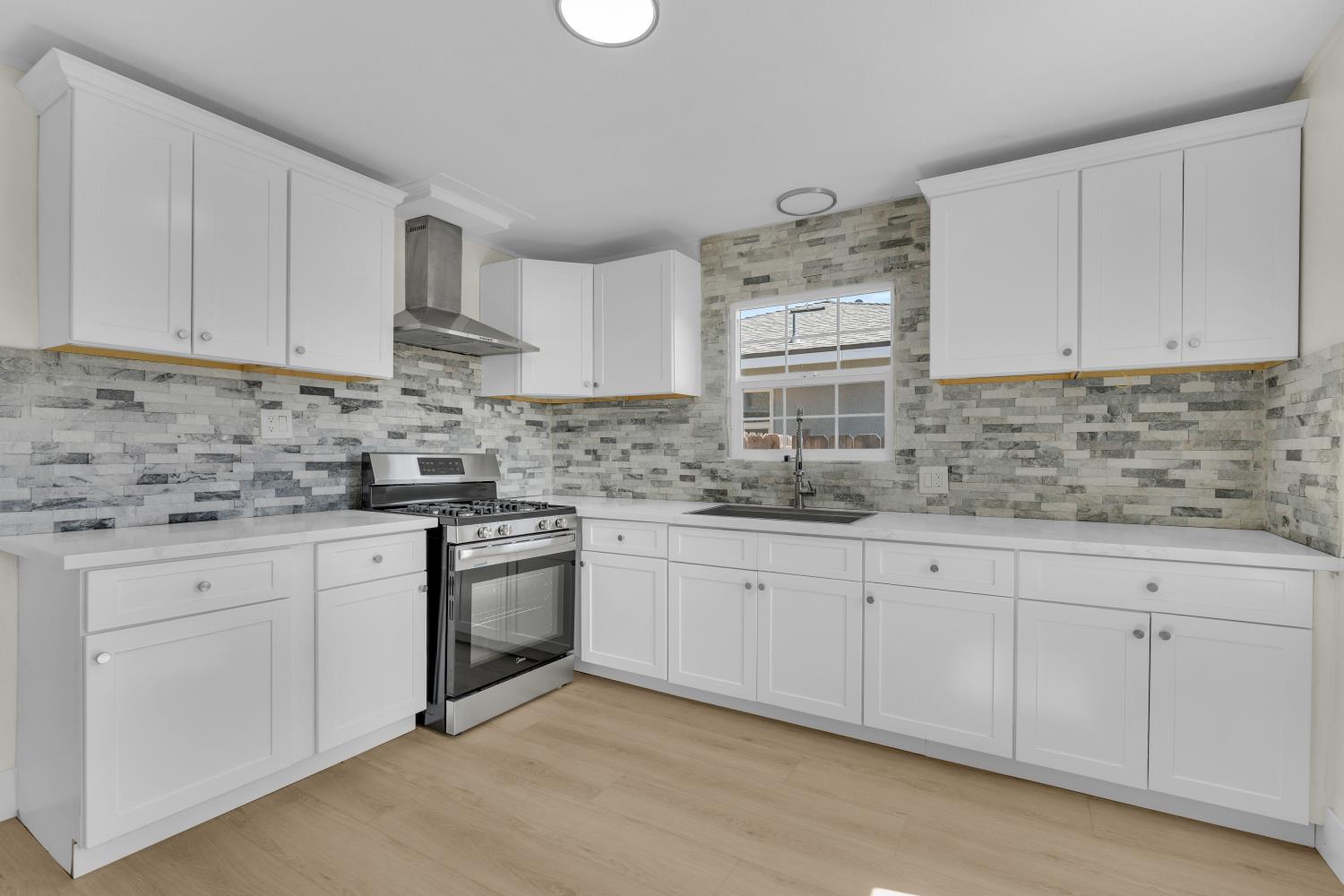 535 West Terrace Avenue Fresno, CA 93705 - Photo 12 of 18 a kitchen with granite countertop white cabinets white stainless steel appliances with a sink and dishwasher