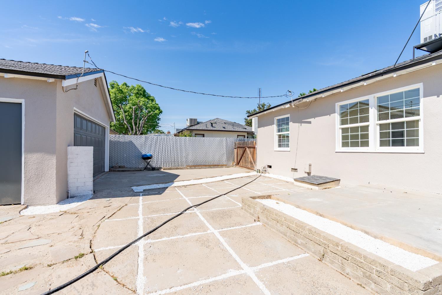 535 West Terrace Avenue Fresno, CA 93705 - Photo 18 of 18 a view of a house with a backyard and a garage